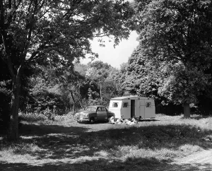 Picnic Prints: A family relaxing on holiday with their 1951 Vauxhall Wyvern and caravan, (1951?)