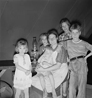 Displaced Person Gallery: Family of six in tent after supper, FSA mobile unit, Merrill, Klamath County, Oregon
