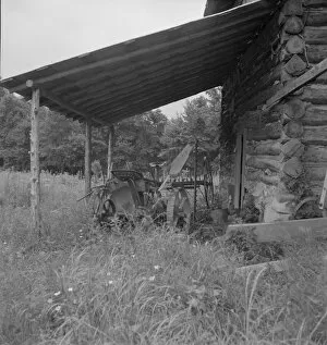 Sharecropper Gallery: Farm machinery drawn under cover of old tobacco barn, Person County, North Carolina, 1939