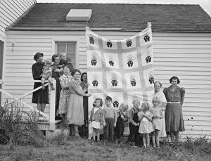Farm women of the 'Helping Hand' club display a pieced quilt... near West Carlton, Oregon, 1939