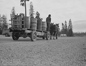 Child Labour Gallery: Farmer and his boy hauling water for drinking and domestic purposes... Boundary County, Idaho