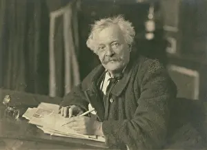 Aged Prints: Felix Nadar seated at writing table, 1905-1910. Creator: Nadar