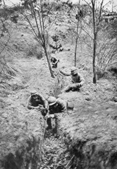Sapper Prints: Fench sappers in gas masks re-laying telephone lines after a bombardment, 1918