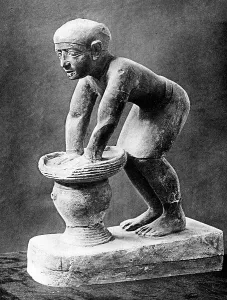Figure of an Ancient Egyptian brewer pressing out fermented bread in a basket, c1910 Figure of an Ancient Egyptian brewer pressing out fermented bread in a basket, c1910