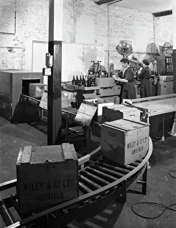 Conveyor Belt Prints: The final stages of bottling whisky at Wiley & Co, Sheffield, South Yorkshire, 1960