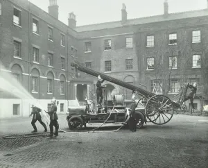 Firefighting Prints: Fireman using a hose, London Fire Brigade Headquarters, London, 1910