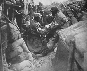 First aid to a wounded man in one of the French trenches, 1915 First aid to a wounded man in one of the French trenches, 1915