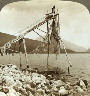 Arranging Prints: Fisherman arranging salmon nets at Balestrand on Sognefjord - Balholm in distance