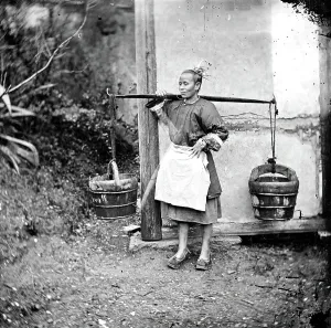 Bucket Prints: Foochow, Fukien province, China: a woman carrying buckets of night-soil
