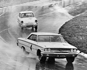 Sears Prints: Ford Galaxie, J. Sears, leads Ford Anglia in wet at Brands Hatch 1963. Creator: Unknown