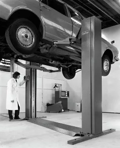 A Ford Zodiac on a Laycock asymmetric lift, 1972. Artist: Michael Walters