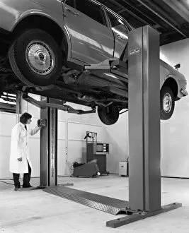 Car Maintenance Gallery: A Ford Zodiac on a Laycock asymmetric lift, 1972. Artist: Michael Walters