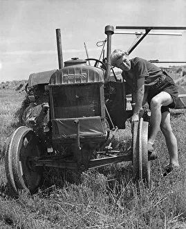 Commercial Vehicles Prints: Fordson tractor, with Land girl 1940 s. Creator: Unknown