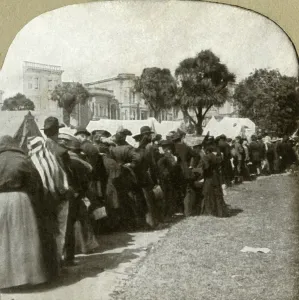World Wide View Co Prints: Forming bread line at Jefferson Square, 1906. Creator: Unknown