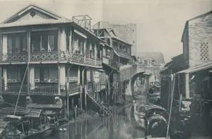 House On Stilts Prints: Fouled Waters Beneath A Bridge Leading To Unlovely Homes of Poverty and Pain, c1935