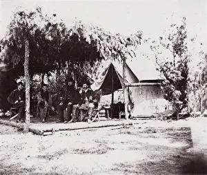 Brady Prints: [Four men in camp under a lean-to of pine boughs], 1861-65. Creator: Unknown