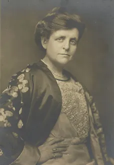 Frances Benjamin Johnston, half-length portrait, turned to the right, facing front, with... 1911. Creator: William H Towles