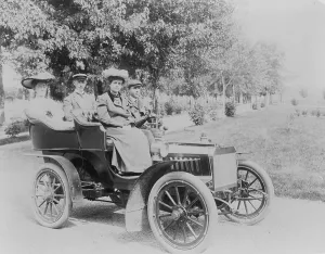Photojournalism Prints: Frances Benjamin Johnston seated with three other people in automobile
