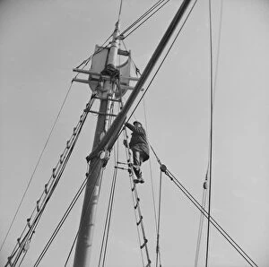 Deck Gallery: Frank Mineo, owner of the Alden, climbs to the crows nest... Gloucester, Massachusetts, 1943