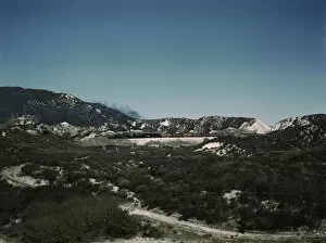 Freight train with two helper engines climbing the steep grade of Cajon Pass (westbound), CA. 1943