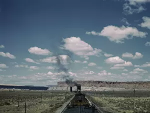 Atchison Topeka Santa Fe Railway Gallery: A freight train stopping for coal and water at a siding enroute to Gallup, New Mexico, 1943