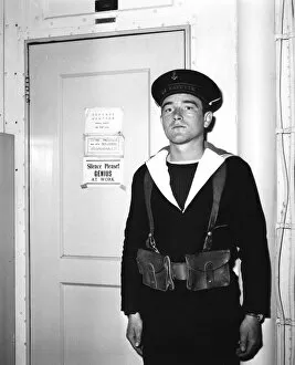 Aircraft Carrier Gallery: A French sentry outside the operations room of the aircraft carrier La Fayette, 1951