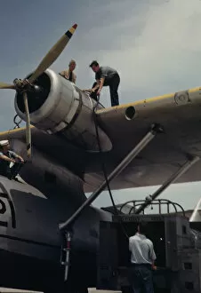 Transparencies Color Gmgpc Gallery: Fueling a plane at the Naval Air Base, Corpus Christi, Texas, 1942. Creator: Howard Hollem