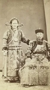 Full-length portrait of wealthy Buriat man and his wife, facing front, between 1870 and 1886. Creator: Unknown