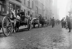 Workers Rights Prints: Garbage carts protected by police, 1911. Creator: Bain News Service