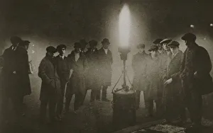 Gathering around an acetylene flare at a traffic control point in the fog, early 20th century Gathering around an acetylene flare at a traffic control point in the fog, early 20th century