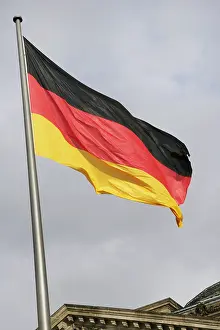 Heritage Prints: German flag next to the Reichstag building, Berlin, Germany, 2025. Creator: LTL