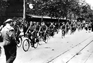 Conqueror Prints: German soldier cycling through the streets of Paris, June 1940