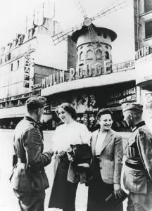 German soldiers chatting up French women outside the Moulin Rouge, occupied Paris, June 1940 German soldiers chatting up French women outside the Moulin Rouge, occupied Paris, June 1940