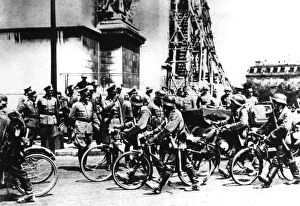 Conquering Gallery: German soldiers marching past the Arc de Triomphe, Paris, 14 June 1940