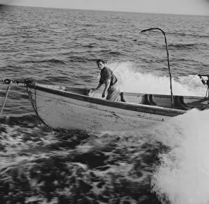 Deck Gallery: Giacomo Frusteri in the prow of the seining boat as it races to... Gloucester, Massachusetts, 1943