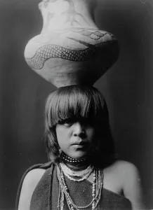 Girl and jar-San Ildefonso, c1927. Creator: Edward Sheriff Curtis