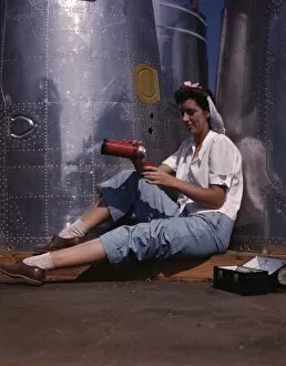 Assembly Line Worker Collection: Girl worker at lunch also absorbing Calif... Douglas Aircraft Company, Long Beach, Calif. 1942