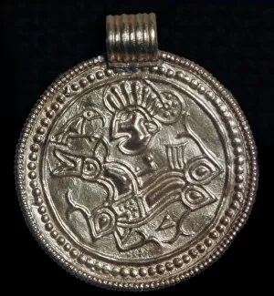 Gold bracteate from Sweden showing Odin and a raven