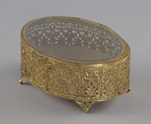 Mae Reeves Prints: Gold metal scrollwork jewelry box from Maes Millinery Shop, 1941-1994. Creator: Unknown
