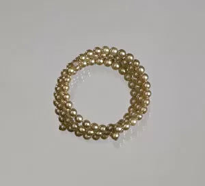 Gold pearl coil bracelet from Mae's Millinery Shop, 1941-1994. Creator: Unknown