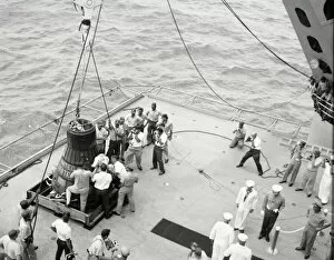 Aircraft Carrier Gallery: Gordon Cooper and capsule on deck, Pacific Ocean, 1963. Creator: NASA