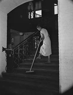 Sweeping Prints: Government charwoman cleaning after regular working hours