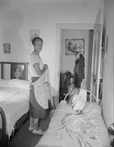 Apartment Gallery: Grandchild of Mrs. Ella Watson, a government charwoman, taking her...nap, Washington, D.C, 1942