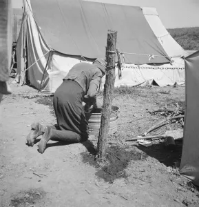 Washtub Collection: A grandmother washing clothes in California, in a contractors camp near Westley, California, 1939