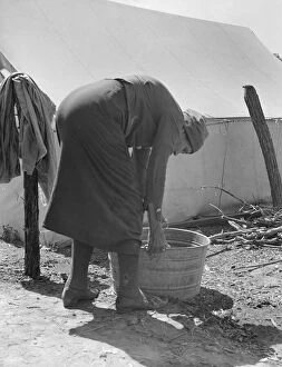 Washtub Collection: A grandmother washing clothes in a migrant camp, Stanislaus County, California, 1939
