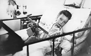 Recovering Prints: Greek boy from Pylos being nursed in the sick bay of the British battleship HMS Malaya