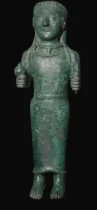 Greek bronze figure holding a pomegranate