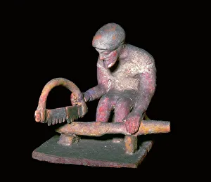 Greek terracotta figure of a man sawing wood, 6th century BC