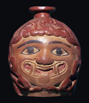 Greek terracotta scent bottle in the shape of a gorgons head made in Rhodes