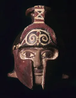 Greek terracotta scent bottle in the shape of a helmeted head, 6th century BC Greek terracotta scent bottle in the shape of a helmeted head, 6th century BC